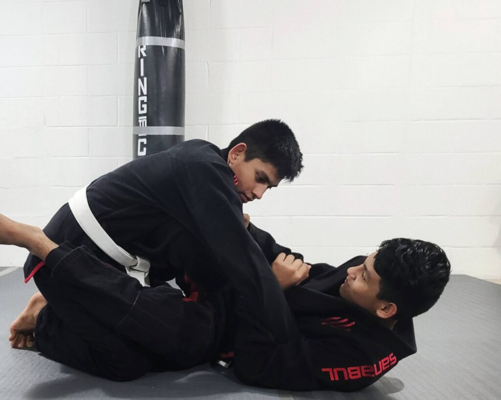 Students practicing guard retention in the Brazillian Jiu-Jitsu class.